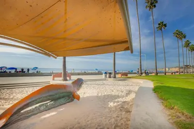a statue of a fish on a bench near the beach at Sand Patch in San Diego