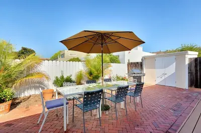 a table and chairs with an umbrella on a patio at Sand Patch in San Diego