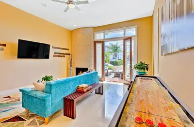 a living room with a blue couch and a tv at Bonair Beauty in San Diego