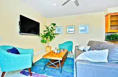 a living room with a couch and chairs and a table at Bonair Beauty in San Diego