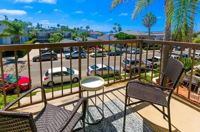 a balcony with chairs and a view of a parking lot at Bonair Beauty in San Diego