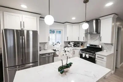 a kitchen with white cabinets and a stainless steel refrigerator at 8354 Adam Unit A 2b 1b by sdstay in Lemon Grove