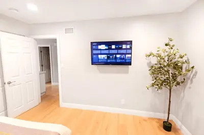 a living room with a tv on a white wall at 8354 Adam Unit A 2b 1b by sdstay in Lemon Grove