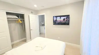 a bedroom with a bed and a tv on the wall at 8354 Adam Unit A 2b 1b by sdstay in Lemon Grove