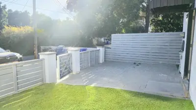 a white fence next to a yard with green grass at 8354 Adam Unit A 2b 1b by sdstay in Lemon Grove