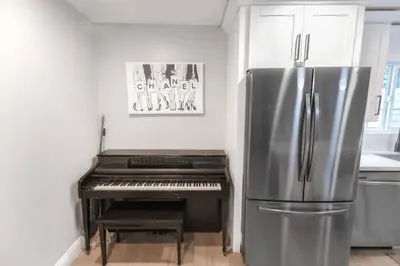 a refrigerator in a kitchen with a piano at 8354 Adam Unit A 2b 1b by sdstay in Lemon Grove