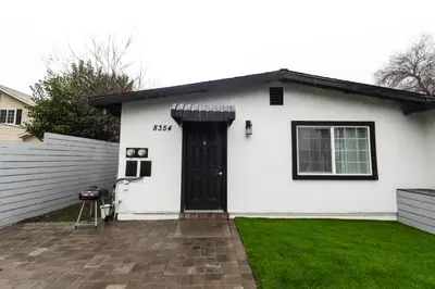 a white house with a black door at 8354 Adam Unit A 2b 1b by sdstay in Lemon Grove