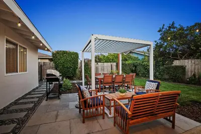 a patio with a table and chairs and a grill at Family Oasis with Hot Tub and Dedicated Workspace in San Diego