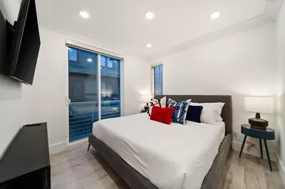 a bedroom with a large bed and a window at Bayside Delight Just Steps to Water in San Diego