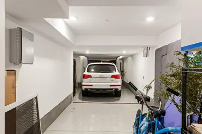 a white car is parked in a garage at Bayside Delight Just Steps to Water in San Diego