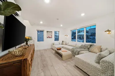 a living room with a couch and a flat screen tv at Bayside Delight Just Steps to Water in San Diego