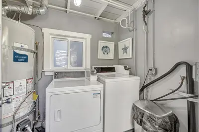 a laundry room with a washer and dryer at Ocean VIEWS! Steps from Victoria Beach, Lux Design in Laguna Beach