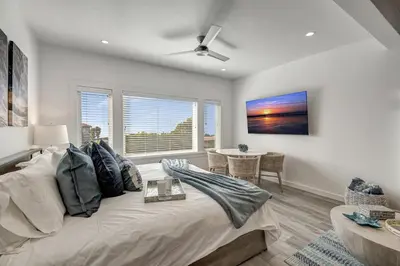 a living room with a large bed and a table at Ocean VIEWS! Steps from Victoria Beach, Lux Design in Laguna Beach