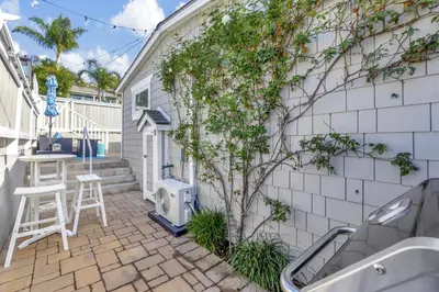 a patio with a tree next to a building at Ocean Views! Detached Villa by Victoria Beach in Laguna Beach