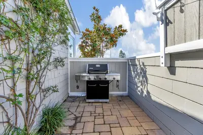 a patio with a grill on the side of a building at Ocean Views! Detached Villa by Victoria Beach in Laguna Beach