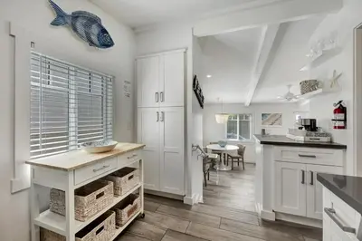 a kitchen with white cabinets and a fish on the wall at Ocean Views! Detached Villa by Victoria Beach in Laguna Beach