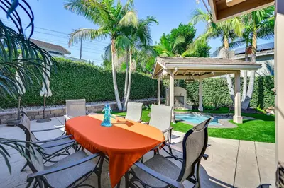 a patio with a table and chairs and a pool at 13 Mi to Downtown San Diego Quiet Home with Spa! in Chula Vista