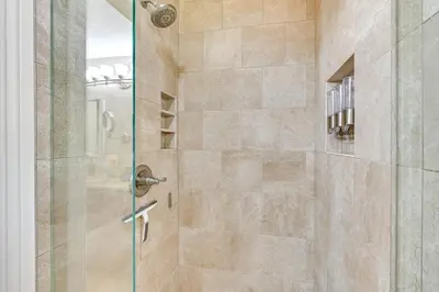 a bathroom with a shower with a glass door at 13 Mi to Downtown San Diego Quiet Home with Spa! in Chula Vista
