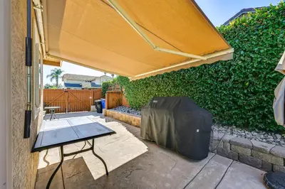 a patio with a table and an umbrella at 13 Mi to Downtown San Diego Quiet Home with Spa! in Chula Vista