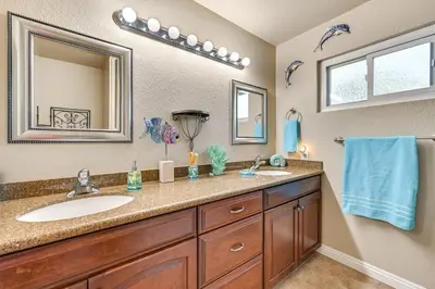 a bathroom with a sink and a mirror at 13 Mi to Downtown San Diego Quiet Home with Spa! in Chula Vista