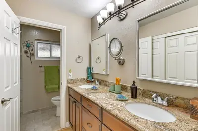 a bathroom with two sinks and a large mirror at 13 Mi to Downtown San Diego Quiet Home with Spa! in Chula Vista