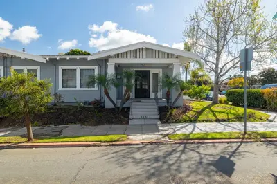 a white house with a porch and a driveway at Falcon Chic Escape - Hot Tub - Modern - Proximity in San Diego
