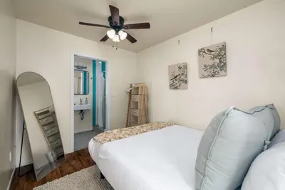 a bedroom with a bed and a ceiling fan at Falcon Chic Escape - Hot Tub - Modern - Proximity in San Diego