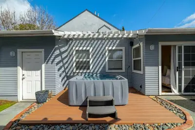 a house with a hot tub on a wooden deck at Falcon Chic Escape - Hot Tub - Modern - Proximity in San Diego
