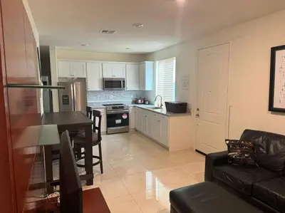 a kitchen and living room with a couch and a table at Luxury 1200 sqft 1bdrm retreat with den in Menifee