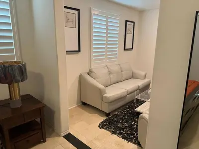 a living room with a couch and a table at Luxury 1200 sqft 1bdrm retreat with den in Menifee