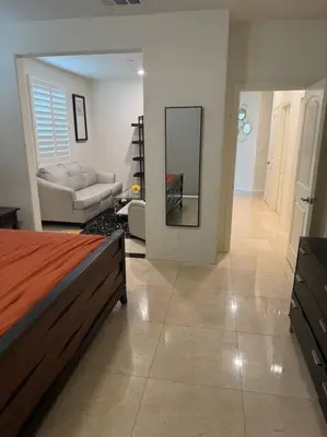 a bedroom with a bed and a living room at Luxury 1200 sqft 1bdrm retreat with den in Menifee