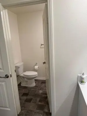 a bathroom with a white toilet in a room at A Tranquil Haven with Elegance in Menifee