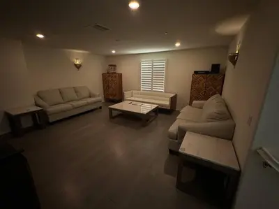a living room with a couch and a table at A Tranquil Haven with Elegance in Menifee