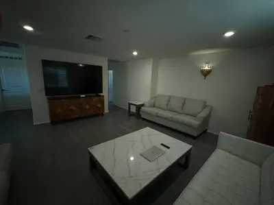 a living room with a couch and a flat screen tv at A Tranquil Haven with Elegance in Menifee