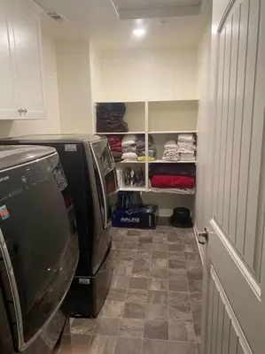 a laundry room with a refrigerator and a tiled floor at A Tranquil Haven with Elegance in Menifee