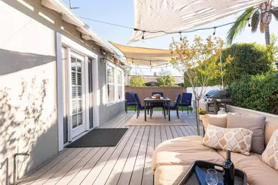 a porch with a couch and a table on a house at Charming Mid-Century Craftsman, Hot Tub with Serene Yard in San Diego