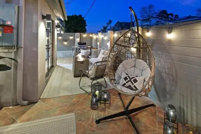 a chair sitting on a patio with lights at Ventana Vista, Ocean View in San Diego