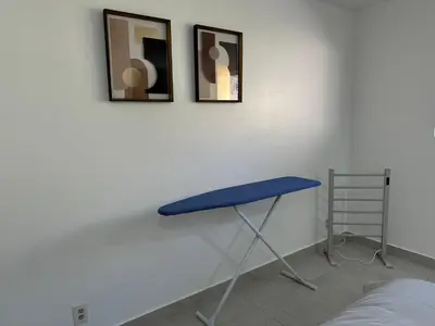 a blue table in a room with two pictures on the wall at Mount Helix Villa in El Cajon