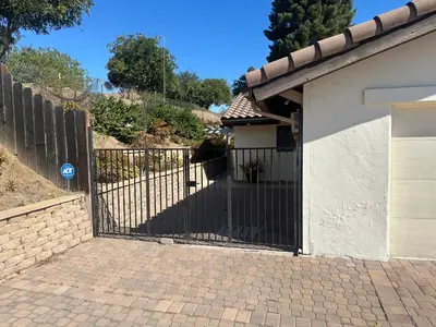 a gate in front of a house with a driveway at Mount Helix Villa in El Cajon