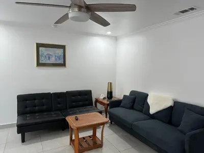 a living room with two couches and a ceiling fan at Mount Helix Villa in El Cajon