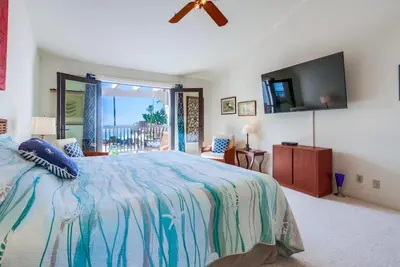 a bedroom with a bed and a flat screen tv at Ocean Views Moonlight Beach Ocean Deck Pool Hot Tub in Encinitas