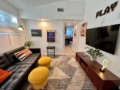 a living room with a couch and two yellow stools at Casa Agave, 2 Bedroom, 1 Bath Guest House, with 3 Beds & Game Room in Vista