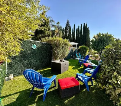 four blue chairs and a television in a yard at Casa Agave, 2 Bedroom, 1 Bath Guest House, with 3 Beds & Game Room in Vista