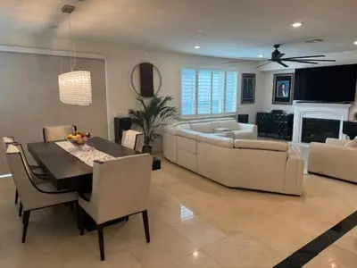 a living room with a dining table and a couch at Elegant Retreat with Private Luxurious Gen Suite in Menifee