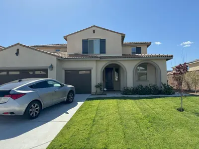 a silver car parked in front of a house at Elegant Retreat with Private Luxurious Gen Suite in Menifee