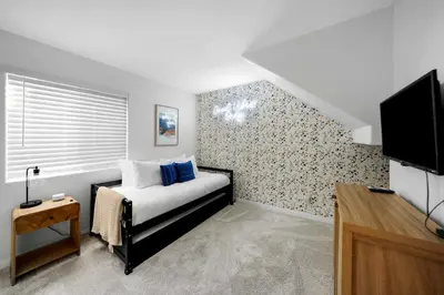 a bedroom with a bed and a tv in it at Beacons Beach Cottage in Encinitas