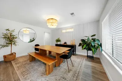 a dining room with a wooden table and a mirror at Leucadia's Beach House w Game Room in Encinitas
