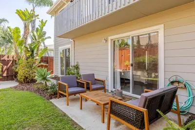 a patio with chairs and a table on a house at Leucadia's Beach House w Game Room in Encinitas
