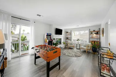a living room with a table with a game at Leucadia's Beach House w Game Room in Encinitas