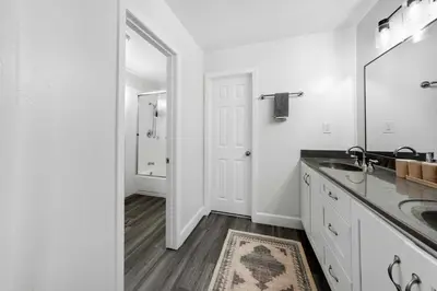 a white bathroom with a sink and a mirror at Leucadia's Beach House w Game Room in Encinitas